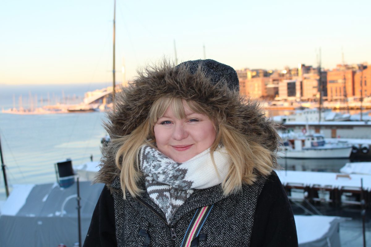 Visiting Oslo in January - smiling woman with big furry hood